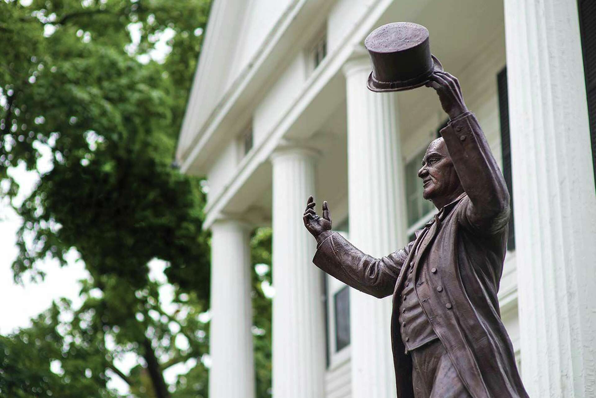 The P.T. Barnum statue tipping its hat outside the library