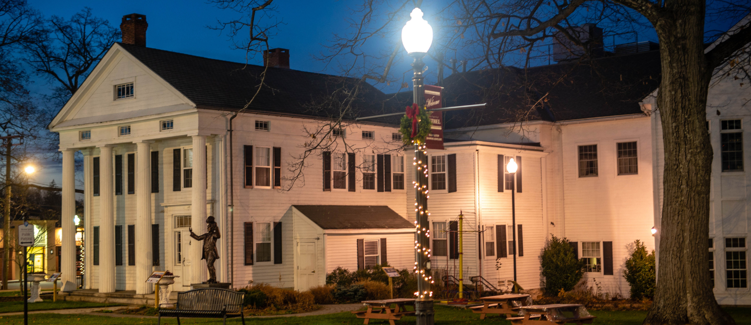 The Bethel Public Library lit up at dusk